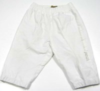 Bílé šusťákové oteplené kalhoty s nápisem zn. Timberland
