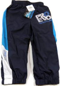 Outlet - Tmavomodré šusťákové kalhoty s nápisem zn. Pro Evolution
