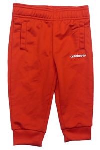 Červené sportovní tepláky s logem zn. Adidas
