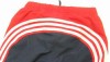 Tmavomodro-červené šusťákové oteplené kalhoty s pruhy zn. Adidas