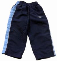 Tmavomodro-modré šusťákové kalhoty zn. Umbro