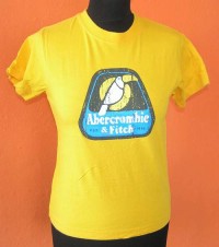 Dámské žluté tričko s potiskem zn. Abercrombie&Fitch
